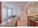 Kitchen island with granite countertop near eat-in kitchen area with light and bright doorway at 1521 Chatfield Pl, Orlando, FL 32814