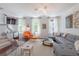 Bright living room featuring a comfortable sofa, modern art, and natural light at 1521 Chatfield Pl, Orlando, FL 32814