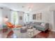 Bright living room features modern decor, hardwood floors, and large windows at 1521 Chatfield Pl, Orlando, FL 32814