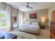 Bright main bedroom featuring neutral tones, plush carpet, stylish decor and ample natural light from large windows at 1521 Chatfield Pl, Orlando, FL 32814