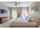 Spacious main bedroom with modern furnishings, large windows, and a mounted television for comfortable living at 1521 Chatfield Pl, Orlando, FL 32814