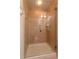 A tiled walk-in shower featuring a glass door and brushed nickel hardware at 1521 Chatfield Pl, Orlando, FL 32814