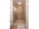 A tiled walk-in shower featuring a glass door and brushed nickel hardware at 1521 Chatfield Pl, Orlando, FL 32814