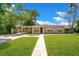 Charming one-story home features a well-manicured lawn and convenient covered parking at 1531 Huntington St, Lakeland, FL 33801