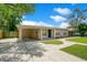 Well-maintained single-story home featuring a covered carport and green lawn at 1531 Huntington St, Lakeland, FL 33801