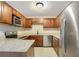 This open kitchen features stainless appliances, granite counter tops, and updated fixtures at 1531 Huntington St, Lakeland, FL 33801