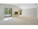 Bright living room with stone fireplace and sliding doors to the pool area at 1531 Huntington St, Lakeland, FL 33801
