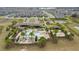 Aerial view of community center with pool, splash pad, lounge seating, and lush palm trees at 15975 Marina Bay Dr, Winter Garden, FL 34787