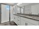 The bathroom features a double sink vanity with granite countertop and a tiled walk-in shower at 15975 Marina Bay Dr, Winter Garden, FL 34787