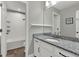 Updated bathroom features granite countertops, white cabinets, and a tub with white herringbone tile at 15975 Marina Bay Dr, Winter Garden, FL 34787
