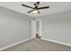 Bright bedroom features a modern ceiling fan, neutral walls, carpet, and white trim at 15975 Marina Bay Dr, Winter Garden, FL 34787