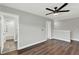 Spacious bedroom with wood flooring, a modern ceiling fan, neutral walls, and white trim at 15975 Marina Bay Dr, Winter Garden, FL 34787