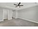 This bedroom boasts neutral walls, plush carpeting, and a ceiling fan for a comfortable atmosphere at 15975 Marina Bay Dr, Winter Garden, FL 34787