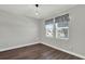 Clean bedroom with hardwood floors, and one large window at 15975 Marina Bay Dr, Winter Garden, FL 34787