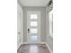 Bright entryway showcases a frosted glass front door, tile floors and adjacent French doors at 15975 Marina Bay Dr, Winter Garden, FL 34787