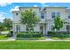 Charming townhome with well-maintained landscaping, complemented by lush green grass and a welcoming facade at 15975 Marina Bay Dr, Winter Garden, FL 34787