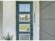 Eye-catching front door with glass panels and a modern design, enhanced by the house number at 15975 Marina Bay Dr, Winter Garden, FL 34787