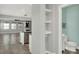 Hallway showing a half bath and the kitchen/living area with breakfast bar at 15975 Marina Bay Dr, Winter Garden, FL 34787