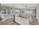 Open concept kitchen with stainless steel dishwasher, granite island and bar seating, seamlessly flowing into the living area at 15975 Marina Bay Dr, Winter Garden, FL 34787