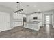 Bright, modern kitchen featuring white cabinets, stainless appliances, and a center island with bar seating at 15975 Marina Bay Dr, Winter Garden, FL 34787