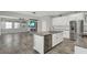 Spacious open-concept kitchen with a center island, stainless steel appliances, and connection to a cozy living area at 15975 Marina Bay Dr, Winter Garden, FL 34787