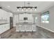 Modern kitchen with stylish pendant lighting over an island with bar stools, offering ample counter space at 15975 Marina Bay Dr, Winter Garden, FL 34787