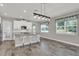 Well-lit kitchen with island seating, offering abundant counter space and natural light from nearby windows at 15975 Marina Bay Dr, Winter Garden, FL 34787