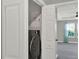 Laundry area with a new washer-dryer combo behind white bi-fold doors, adjacent to the Primary at 15975 Marina Bay Dr, Winter Garden, FL 34787