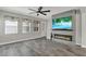 Bright living room features a modern fireplace, large TV, and tile flooring at 15975 Marina Bay Dr, Winter Garden, FL 34787