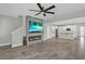 Open-concept living area flows into the kitchen, featuring a fireplace and tile floors at 15975 Marina Bay Dr, Winter Garden, FL 34787
