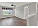 Bright loft features wood flooring, a modern ceiling fan, and neutral walls at 15975 Marina Bay Dr, Winter Garden, FL 34787