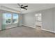 Spacious main bedroom boasts bright windows, tray ceiling, ceiling fan, and ensuite bathroom at 15975 Marina Bay Dr, Winter Garden, FL 34787
