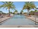 Community pool with accessibility railings, lounge seating, and brick border at 15975 Marina Bay Dr, Winter Garden, FL 34787