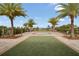 A community green space with turf and shade trees offers an area for relaxation and socializing at 15975 Marina Bay Dr, Winter Garden, FL 34787