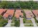Aerial view of well-maintained homes with mature landscaping, and red tiled roofs at 1638 Whitney Isles Dr, Windermere, FL 34786