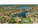 Stunning aerial view showcasing community homes, scenic lakes, a pool, and tennis courts at 1638 Whitney Isles Dr, Windermere, FL 34786