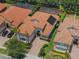 Aerial view of home with a terra cotta roof and screened in pool, surrounded by lush landscaping at 1638 Whitney Isles Dr, Windermere, FL 34786