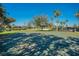Outdoor basketball court near the lake with playground equipment and a volleyball court at 1638 Whitney Isles Dr, Windermere, FL 34786