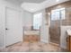Bathroom showcasing a tub with glass block window, walk-in shower and a wood vanity with a sink at 1638 Whitney Isles Dr, Windermere, FL 34786