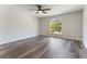 A spacious bedroom with wood floors and a bright window allows plenty of natural light at 1638 Whitney Isles Dr, Windermere, FL 34786