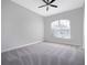 A vacant bedroom has neutral paint, light gray carpet, a ceiling fan and a window for natural light at 1638 Whitney Isles Dr, Windermere, FL 34786