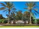 Elegant Belmere community entrance sign with brick pillars and palm trees at 1638 Whitney Isles Dr, Windermere, FL 34786