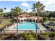 A large community pool with lounge chairs is surrounded by tropical landscaping and palm trees at 1638 Whitney Isles Dr, Windermere, FL 34786