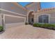 Charming house featuring a tile roof, manicured landscaping, and a paver driveway at 1638 Whitney Isles Dr, Windermere, FL 34786
