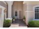 A welcoming front porch with tiled floor, column, and manicured landscaping at 1638 Whitney Isles Dr, Windermere, FL 34786