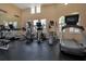 Well-lit gym with cardio equipment, elliptical machines, and large arched windows at 1638 Whitney Isles Dr, Windermere, FL 34786