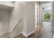 Bright hallway features wood flooring and a view into a naturally lit bedroom at 1638 Whitney Isles Dr, Windermere, FL 34786