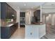 Bright kitchen with dark cabinets, granite countertops, and stainless steel appliances at 1638 Whitney Isles Dr, Windermere, FL 34786
