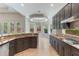Modern kitchen with granite countertops, stainless steel appliances, and dark wood cabinetry at 1638 Whitney Isles Dr, Windermere, FL 34786