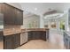 Spacious kitchen with granite countertops, stainless steel appliances and dark cabinets at 1638 Whitney Isles Dr, Windermere, FL 34786